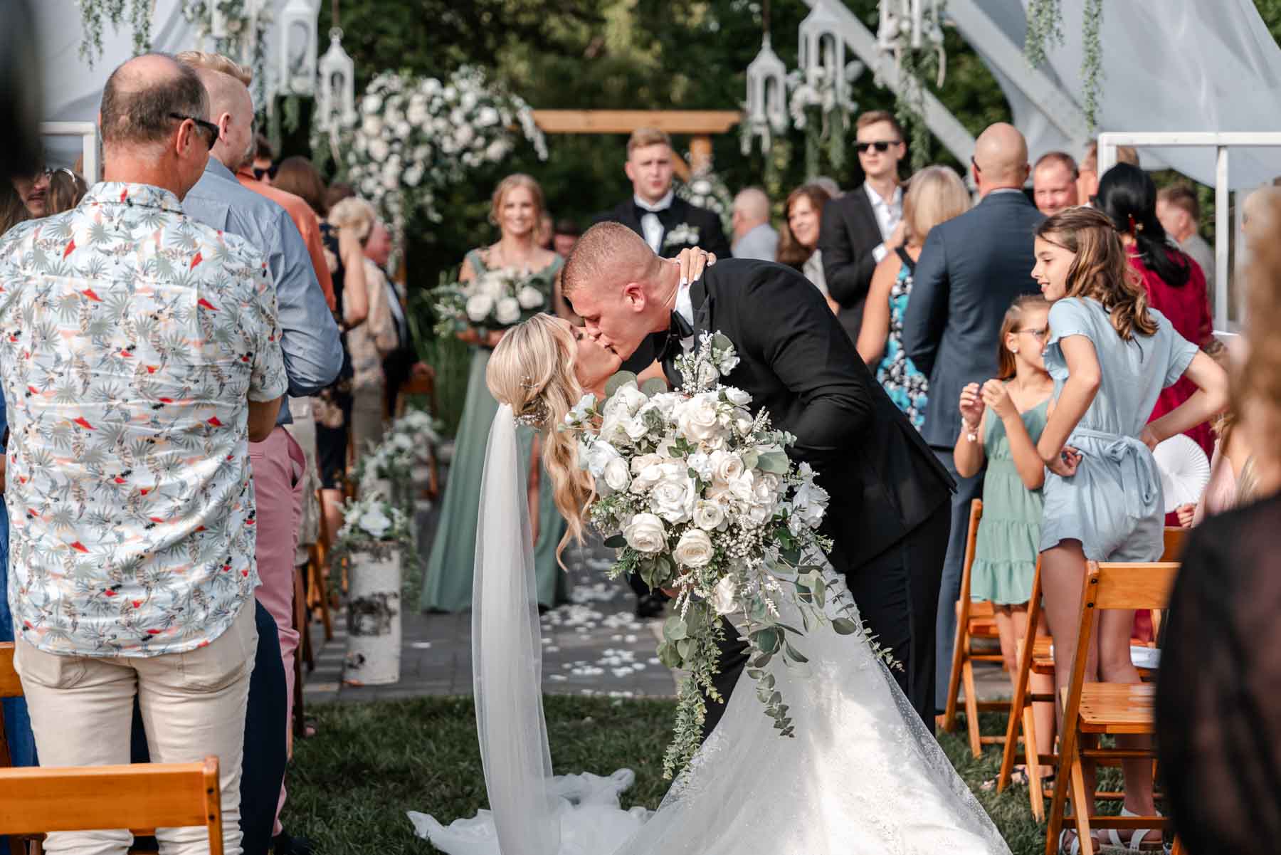 Bride and Groom kissing wedding recessional