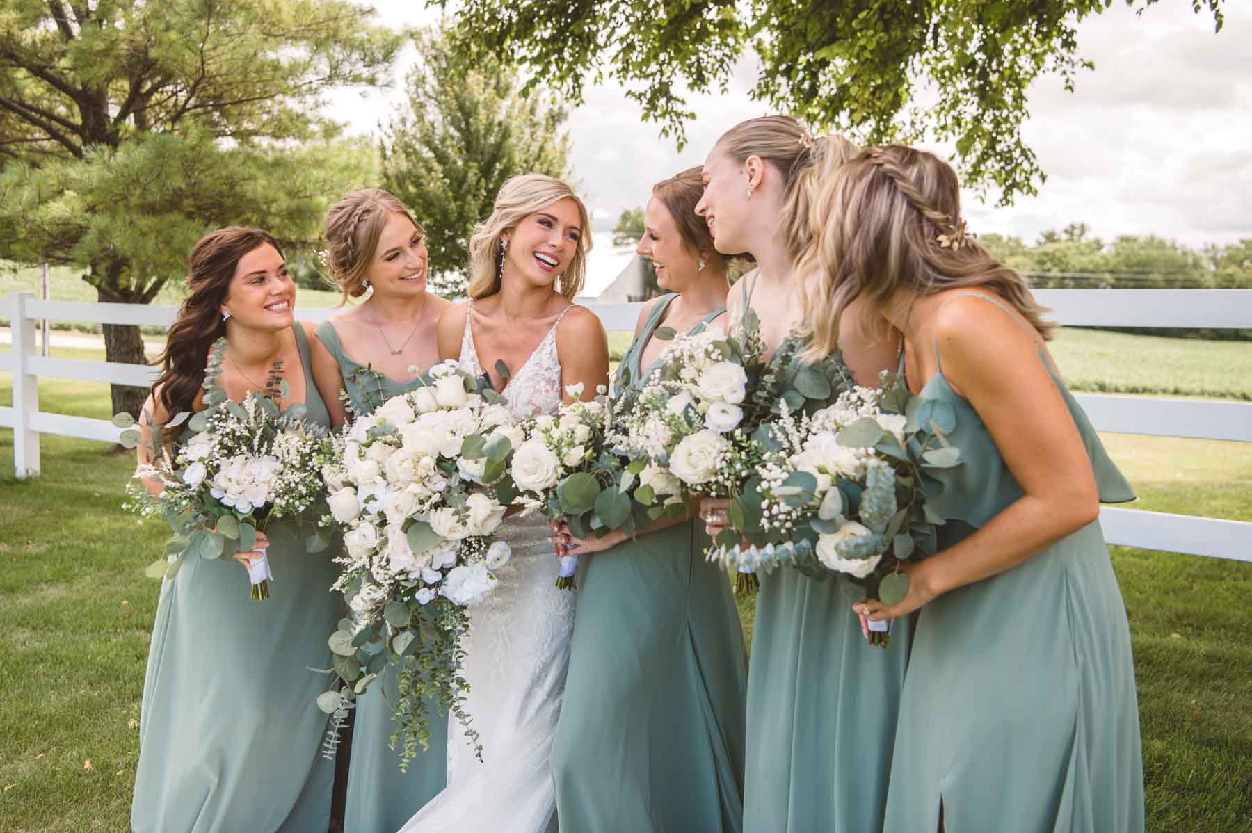 Bride smiling with her bridesmaids