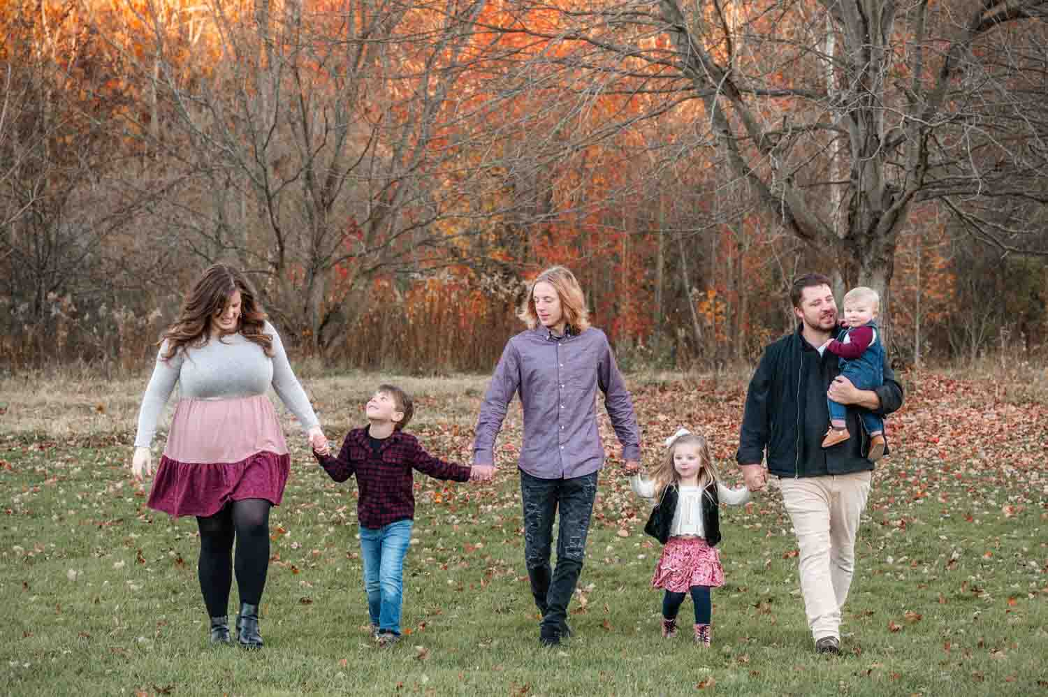 Family walking together holding hands in fall