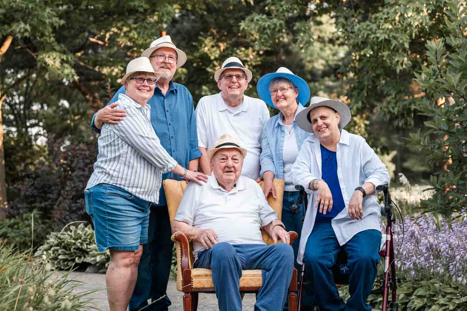 Family image of five siblings with their dad all wearing hats