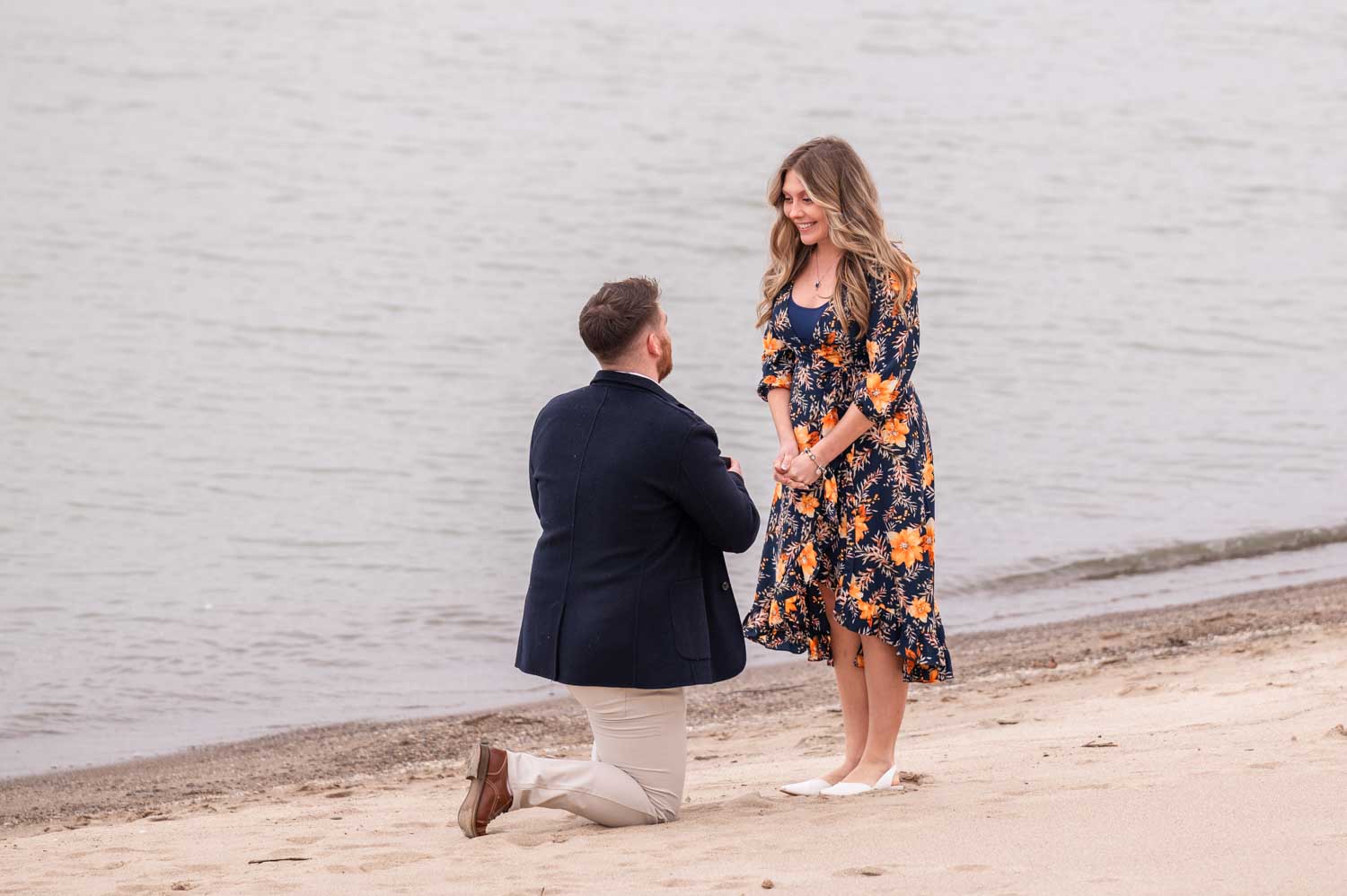 Man proposing to his girlfriend on the beach