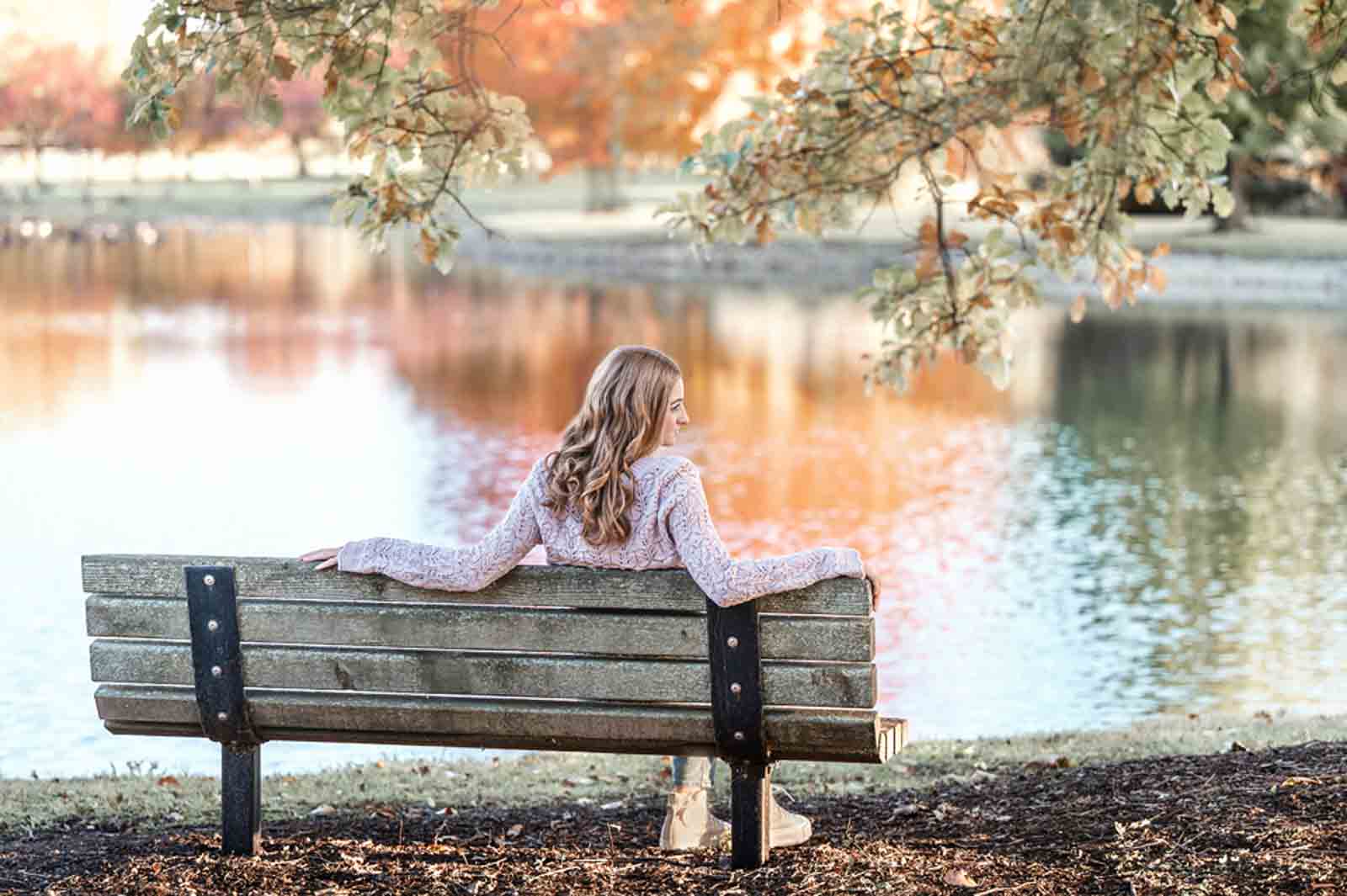 Senior Girl sitting in a chair by a pond